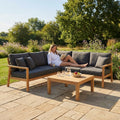 Garden corner sofa set with charcoal cushions and teak table