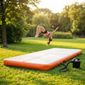 Inflatable gymnastics mat in orange and grey designed for home and gym use