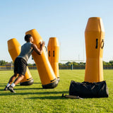 High-visibility American football training dummies in yellow PVC
