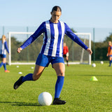 Women's football kit with long-sleeved striped shirt, shorts, and knee-high socks