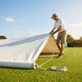 Green heavy-duty baseball field tarp with reinforced edges and handles