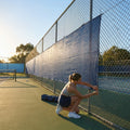Green Tennis Court Windbreaks on an outdoor tennis court